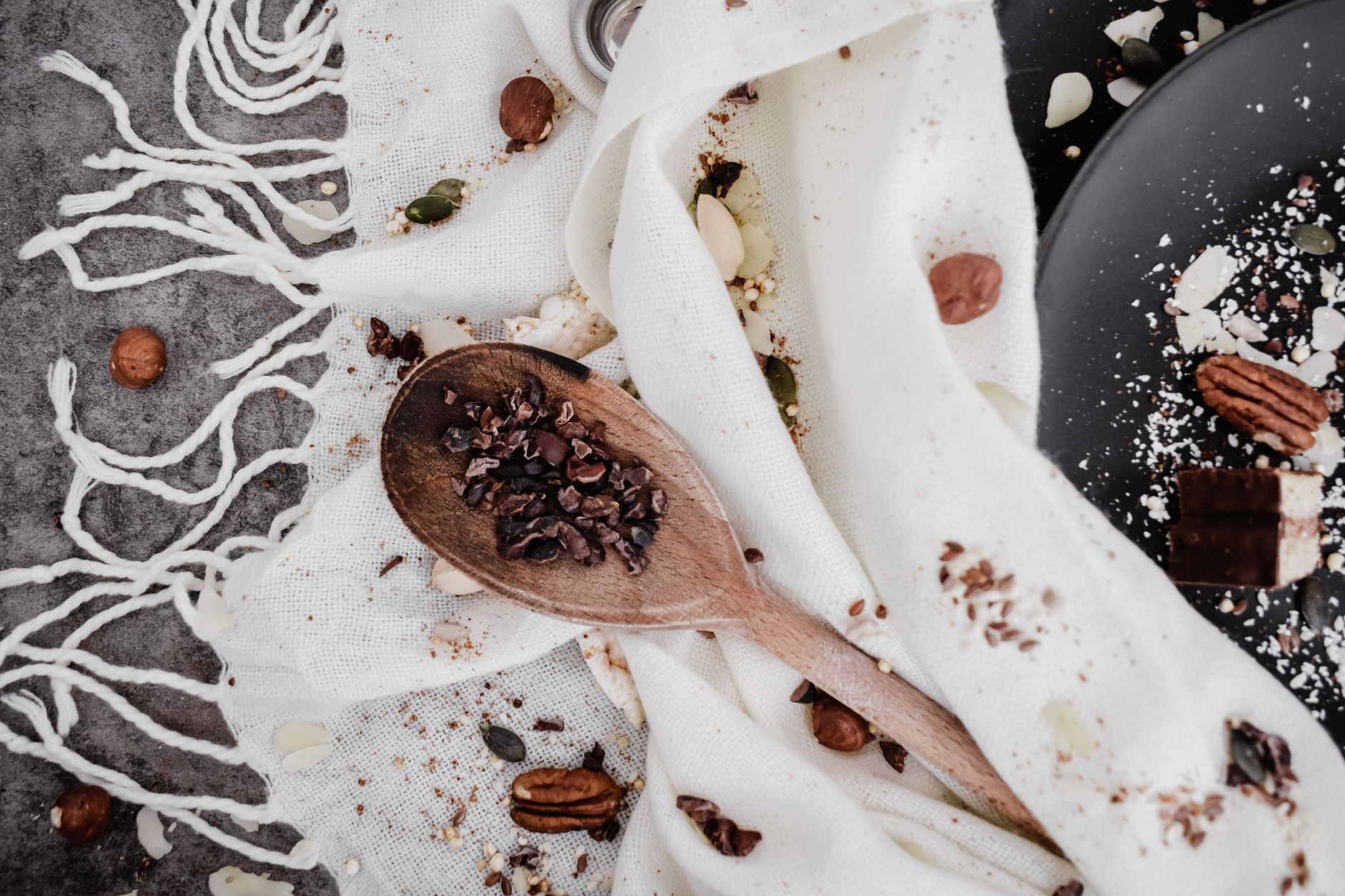 Nuts, seeds, and spices arranged on a wooden board